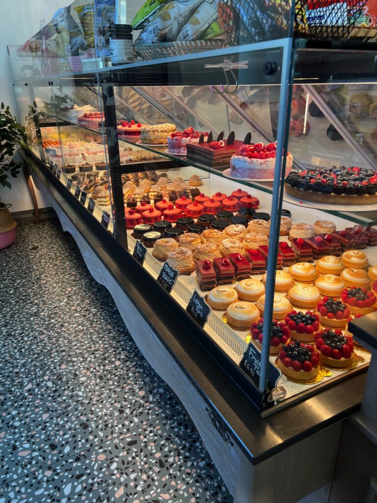 An endless variety of mouth watering pastries in a long glass case.